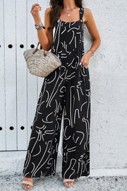 Black abstract scribble wide leg jumpsuit with square neckline and pockets.