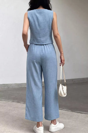 Light blue linen-blend two-piece set with sleeveless crop top and wide-leg pants.