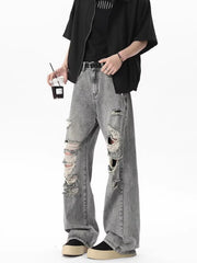 Men's light gray distressed wide-leg jeans with frayed rips.
