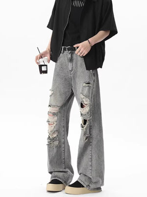 Men's light gray distressed wide-leg jeans with frayed rips.