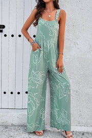 Light green abstract scribble wide leg jumpsuit with pockets and button straps.
