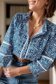 Peacock blue medallion print poet blouse with ruffled neckline and cuffs, 100% polyester