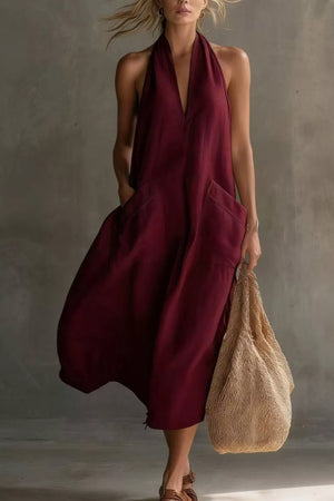 Burgundy halter midi dress with deep V-neck and large front pockets.