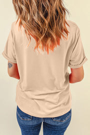 Tan t-shirt with rolled sleeves and a graphic detail on the left sleeve.