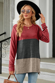 Colorblock long sleeve tee in red, charcoal, and camel with a rounded neckline and side slits.