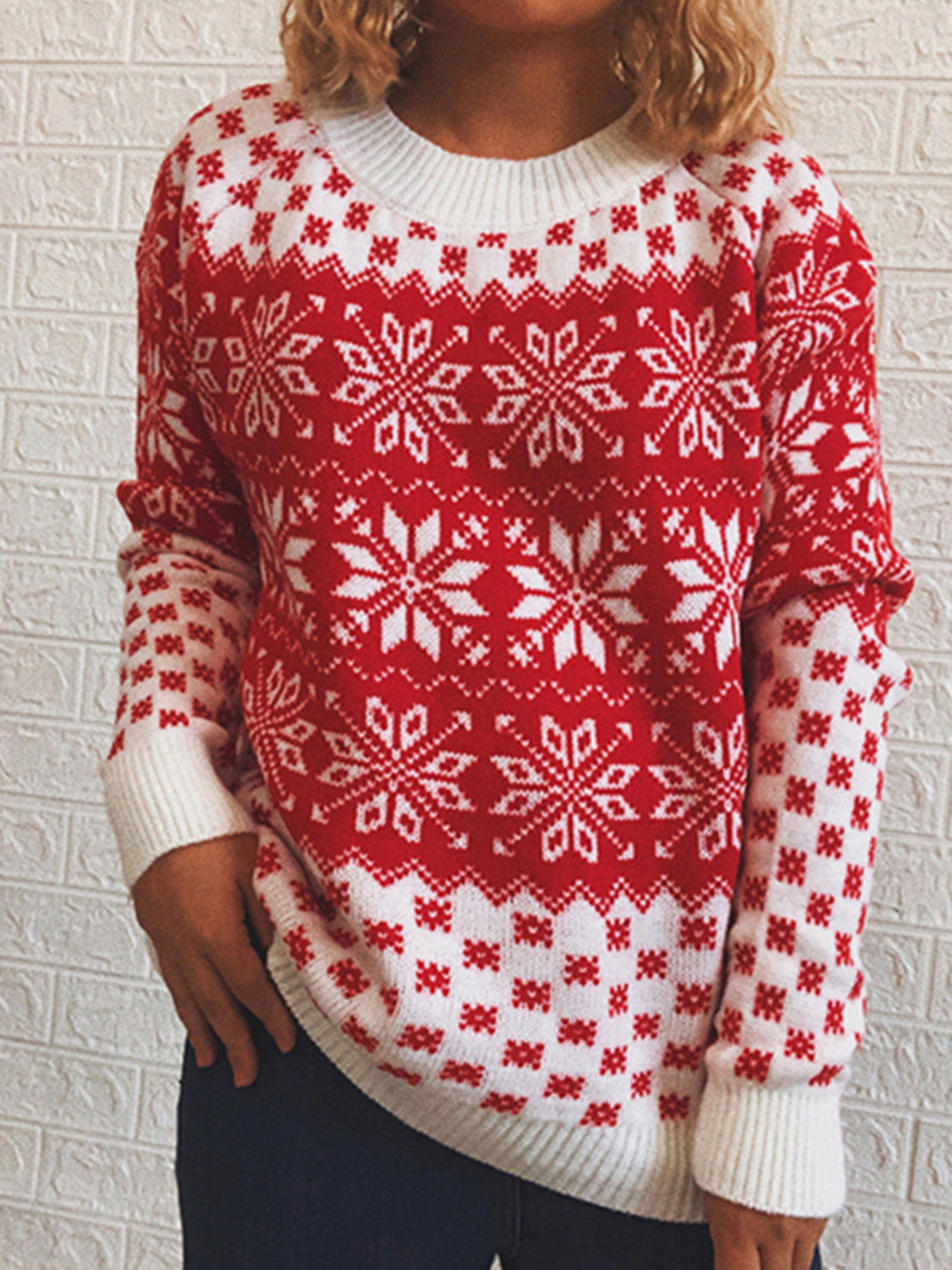 Red and white acrylic knit sweater with snowflake pattern and crew neck.
