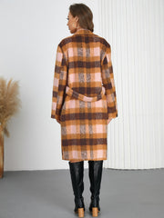 Belted overcoat in plaid bouclé with pink and brown tones, tied at the waist.