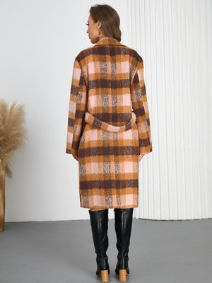 Belted overcoat in plaid bouclé with pink and brown tones, tied at the waist.
