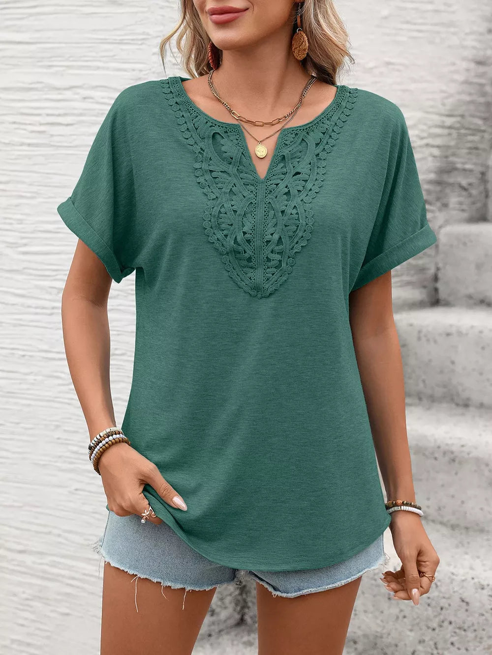 Dark green relaxed fit t-shirt with lace inset neckline and cuffed short sleeves.