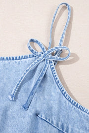 Light blue denim sundress with tie straps and ruffled hem detail.