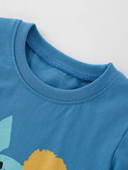 Toddler graphic tee in cerulean cotton with abstract dinosaur graphic detail.