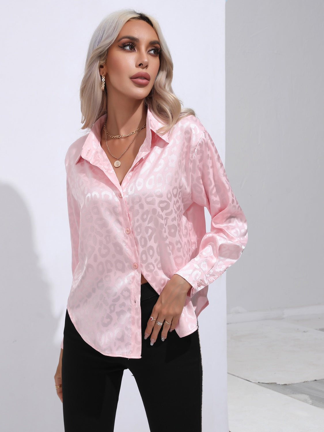 Blush pink satin leopard print button-down shirt with a collared neckline and long sleeves.