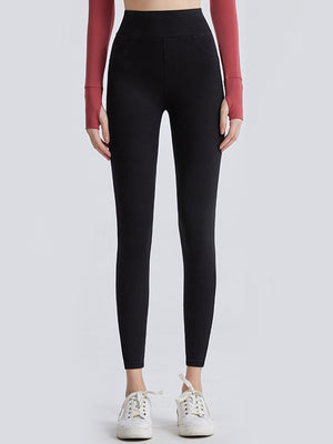 Black high-waisted leggings with faux pocket details and a smooth finish.