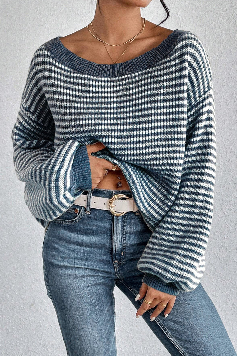 Blue striped off-shoulder knit pullover sweater with wide sleeves.