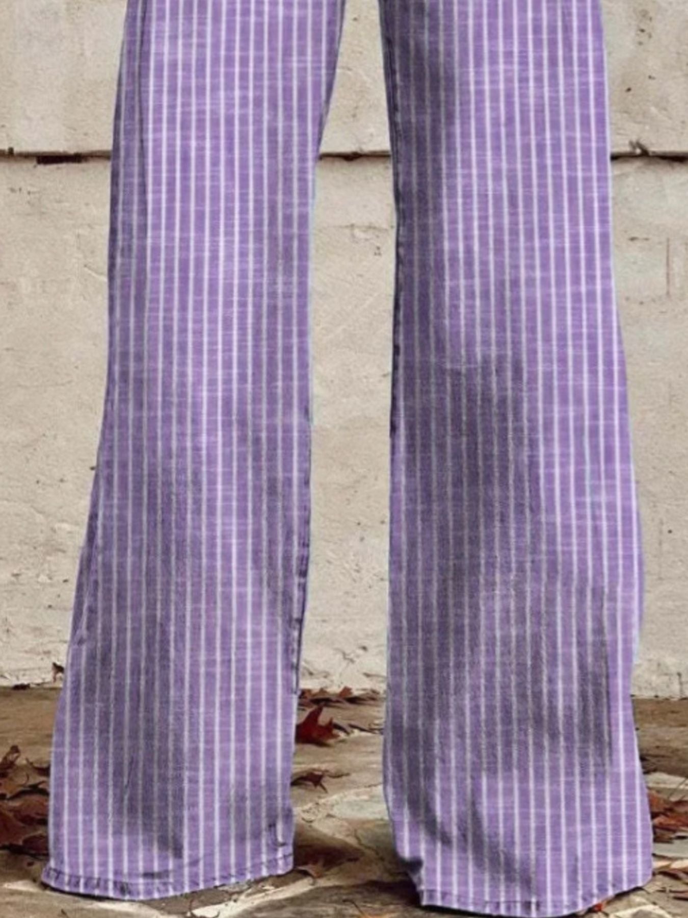 Purple high-waisted wide-leg jeans with white vertical stripes and pockets.