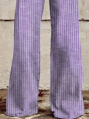Purple high-waisted wide-leg jeans with white vertical stripes and pockets.