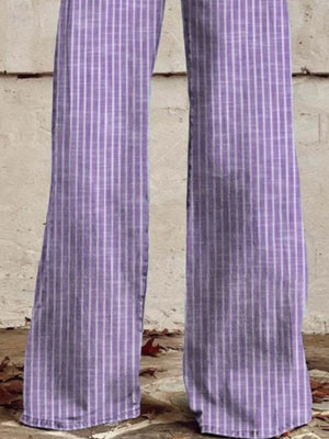 Purple high-waisted wide-leg jeans with white vertical stripes and pockets.