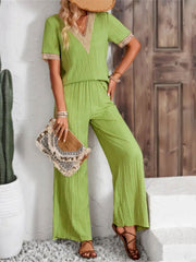 Lime crinkle knit v-neck co-ord set with embroidered trim and wide leg pants.