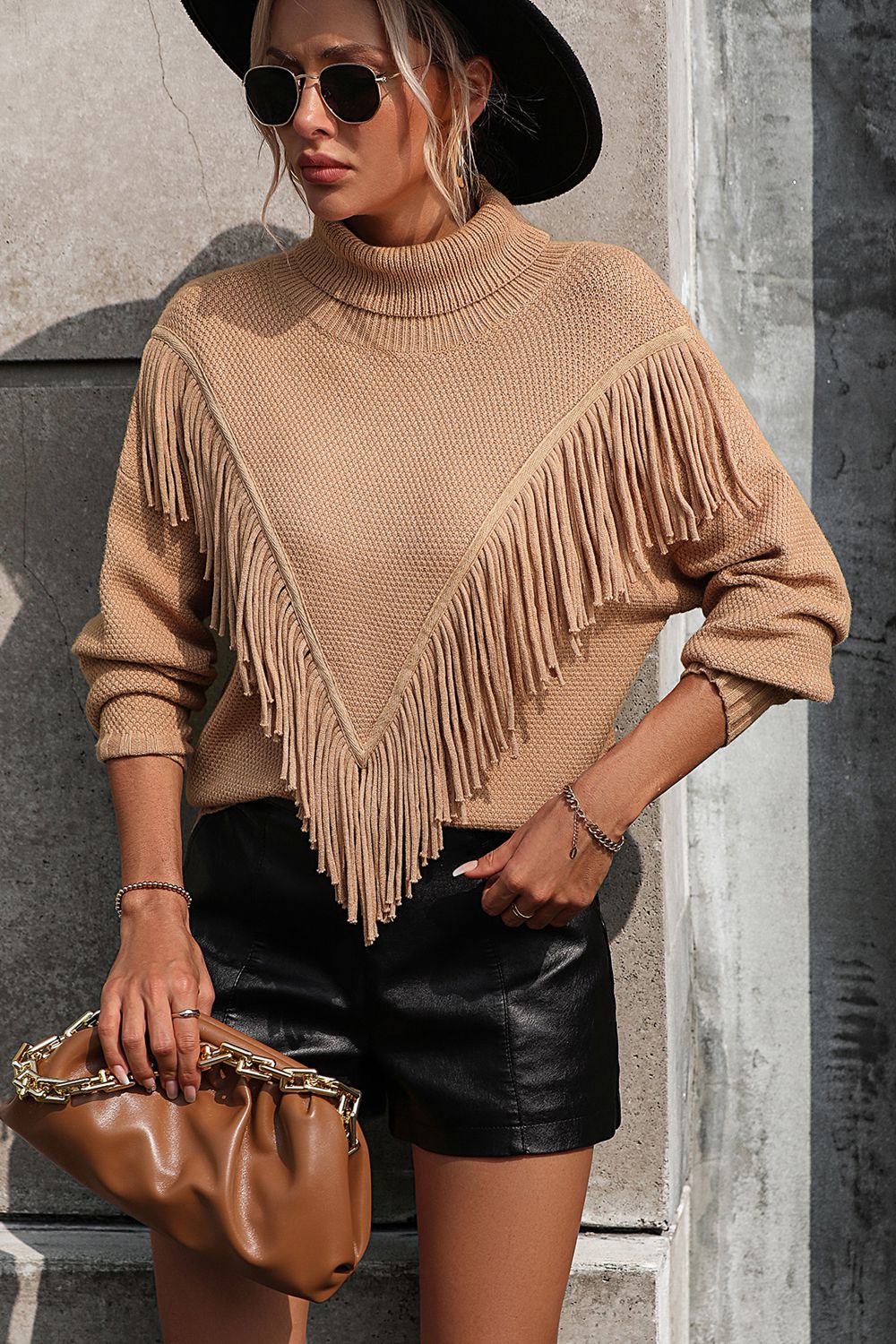 Beige turtleneck sweater with chevron fringe detail and long sleeves.
