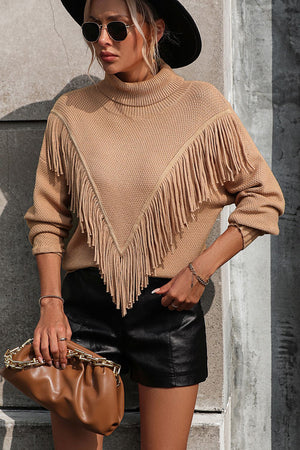 Beige turtleneck sweater with chevron fringe detail and long sleeves.