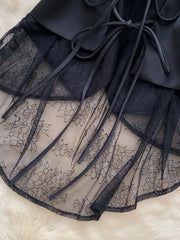 Black lace-embellished button-down vest coat with tie detail and floral lace overlay.