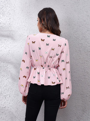 Blush pink peplum blouse with allover butterfly print, cinched waist, and balloon sleeves.