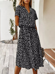 Black and white animal print midi dress with tied waist, button-down detail and short sleeves.