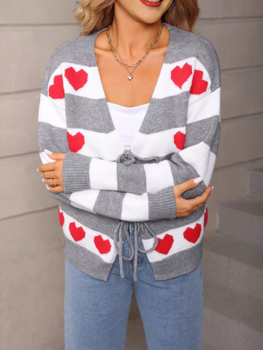 Grey and white striped cardigan with red hearts, tie-front closure, acrylic knit.