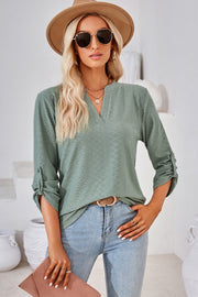 Light green textured henley shirt with roll-tab sleeves and V-neck