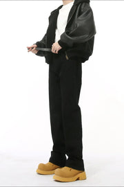 Black mid-rise flared leg tailored trousers with a zipper detail.