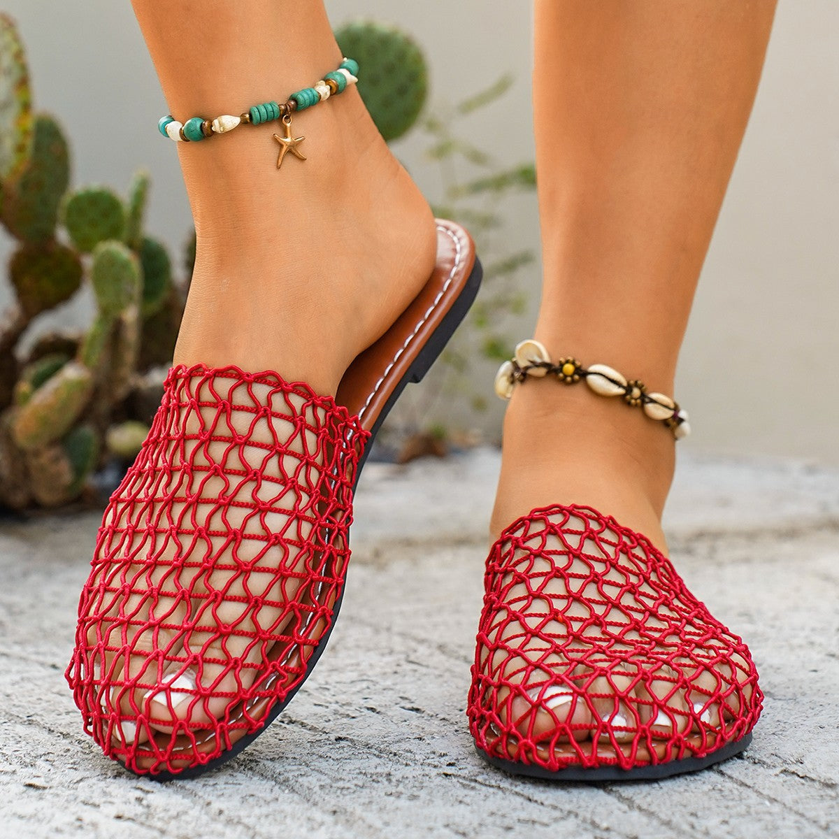 Red woven mule sandals with open toe and brown sole.