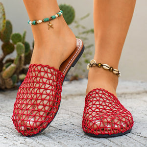 Red woven mule sandals with open toe and brown sole.