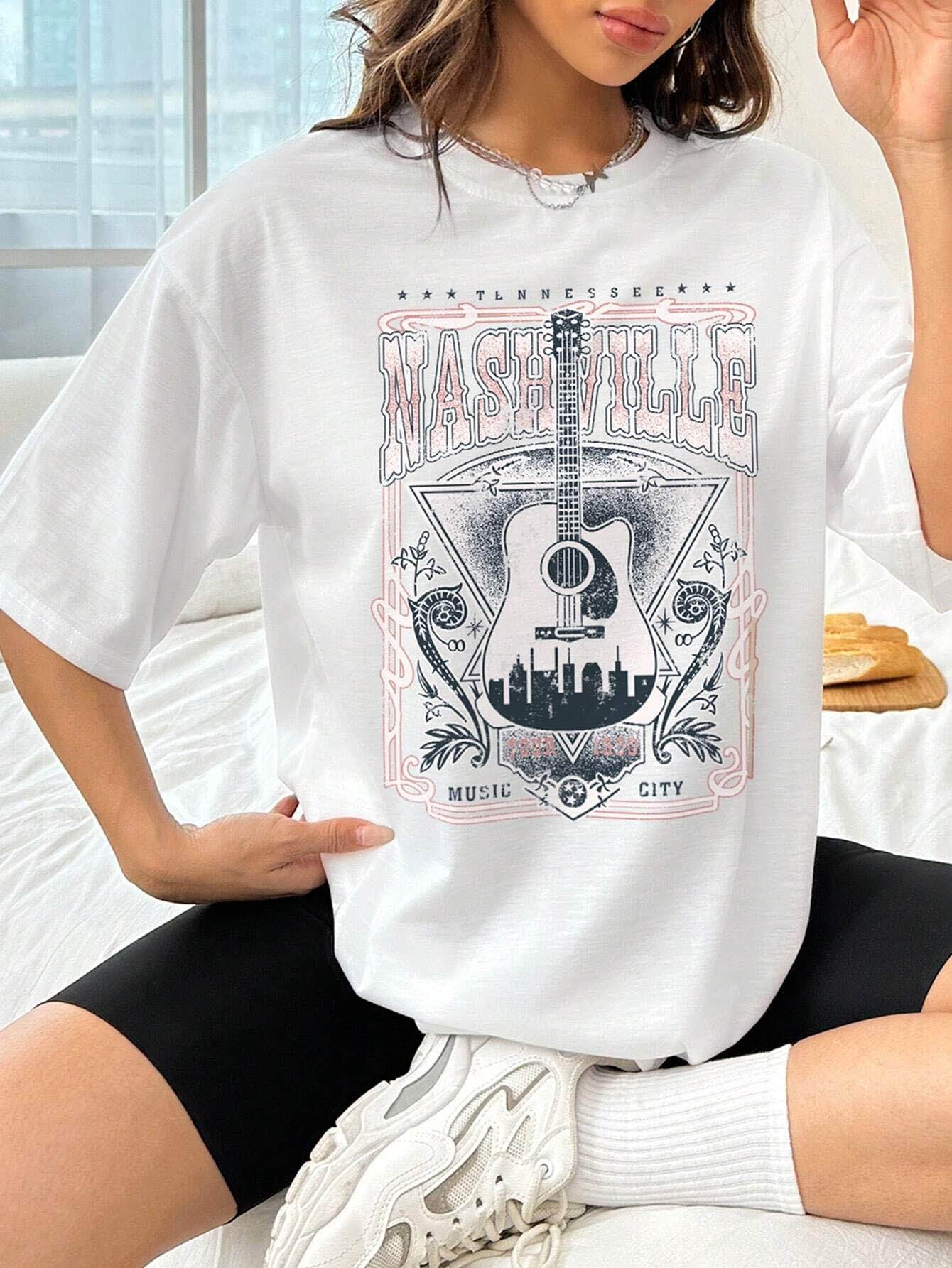 White oversized graphic tee with Nashville Music City guitar and skyline design