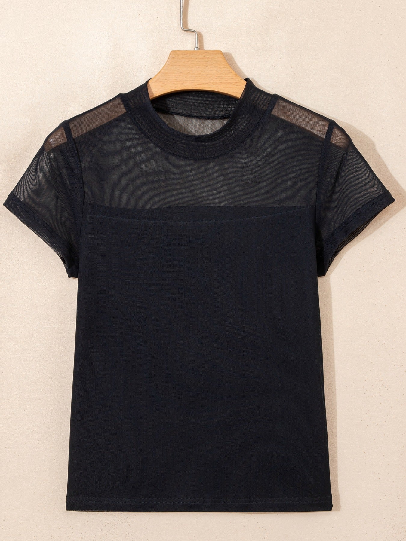 Black sheer mesh cap sleeve t-shirt with a high neckline and opaque bottom half.