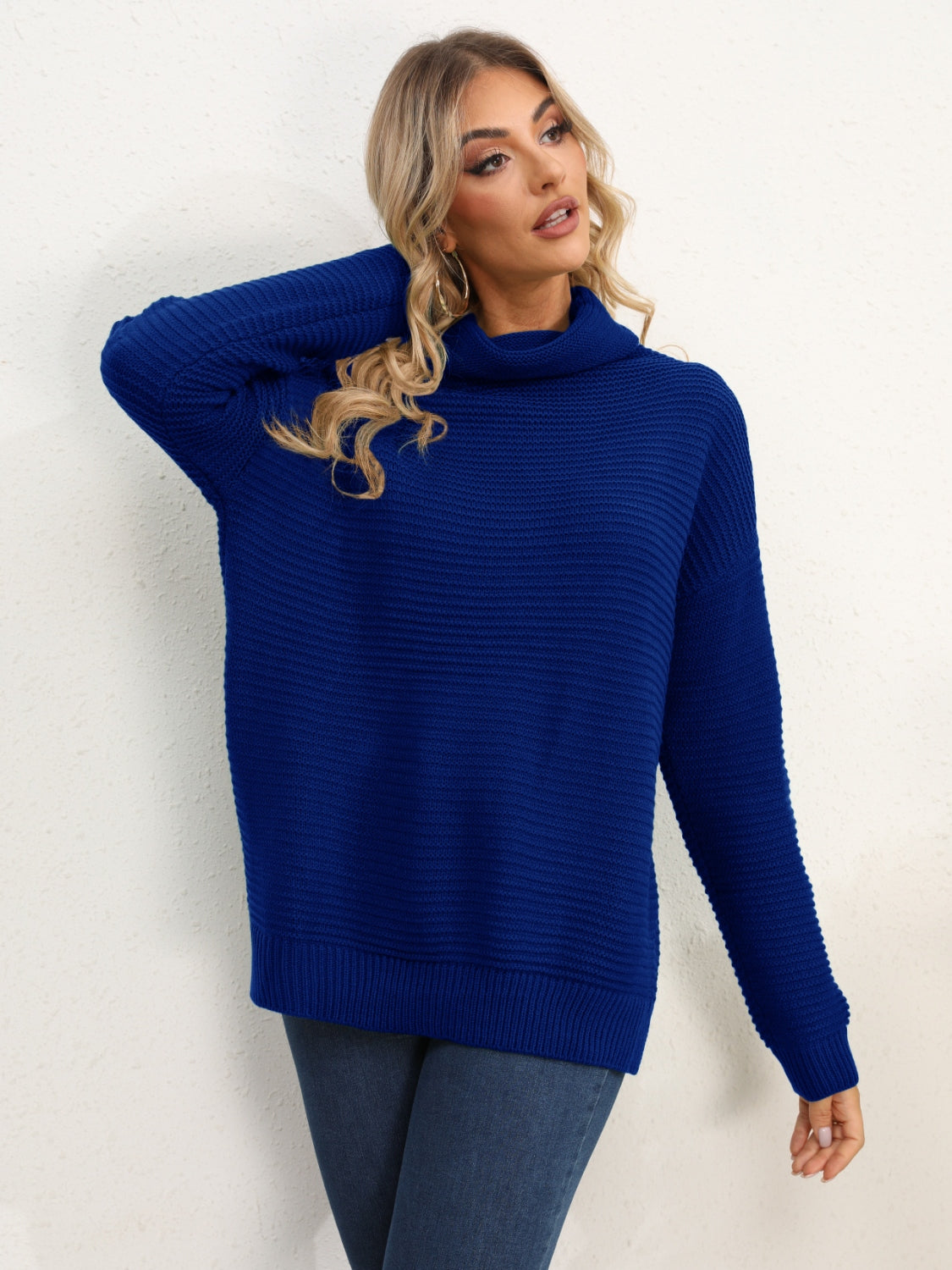 Textured knit oversized turtleneck pullover in dark blue acrylic with a relaxed fit.