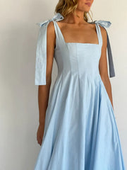 Light blue maxi dress with square neckline and bow-tie shoulder straps.