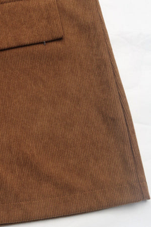 Brown corduroy blazer detail showing a pocket and textured fabric.