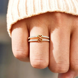 Double band ring with heart and infinity symbols, adorned with zircon stones, silver tone.