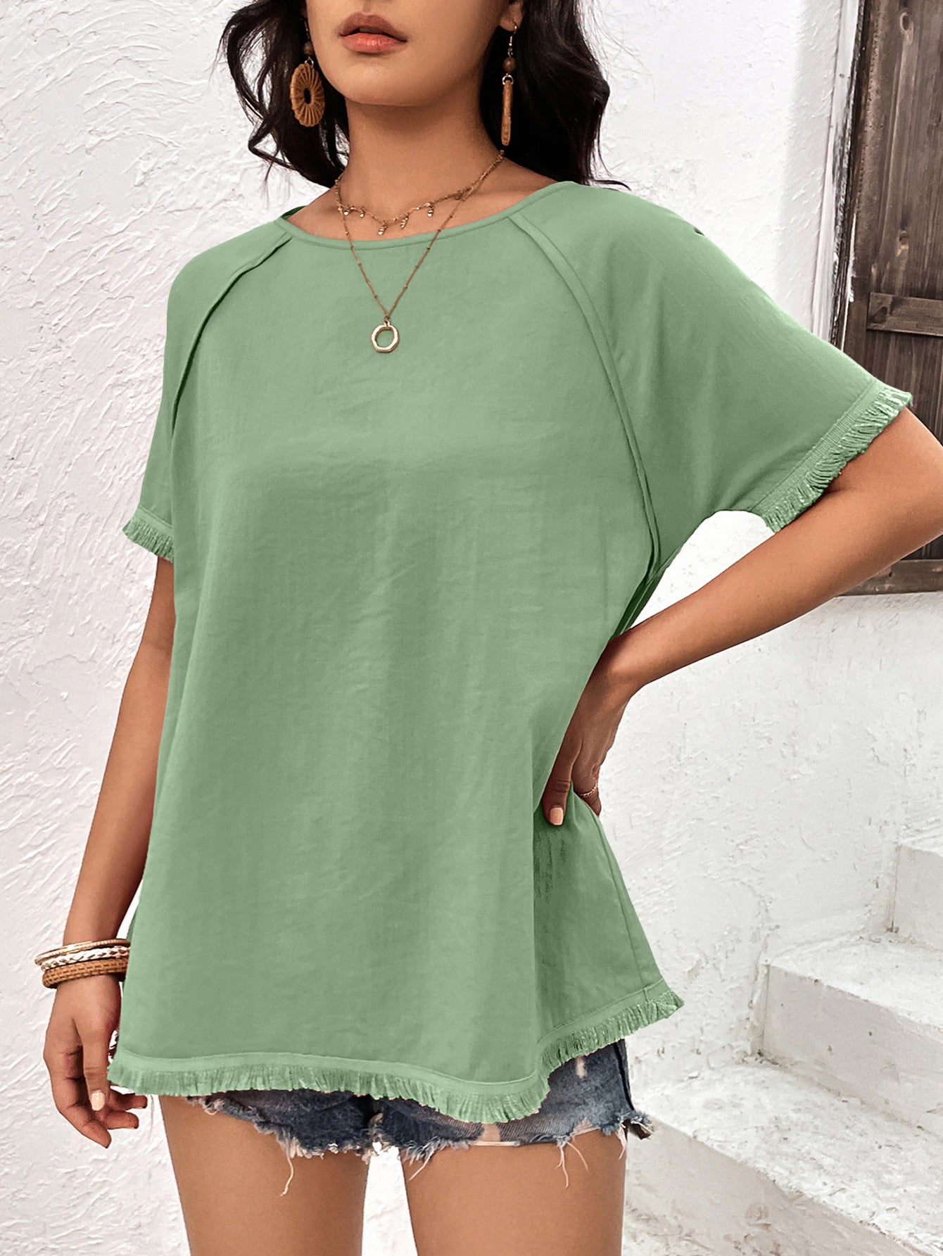 Light green raglan sleeve tee with fringed hem and cuffs.