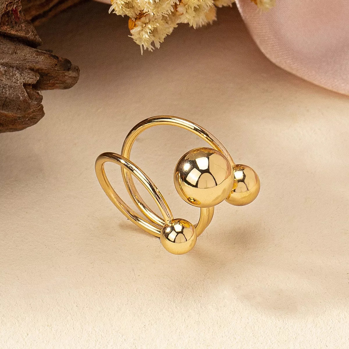 Gold alloy multi-layered ball ring with three polished spheres.