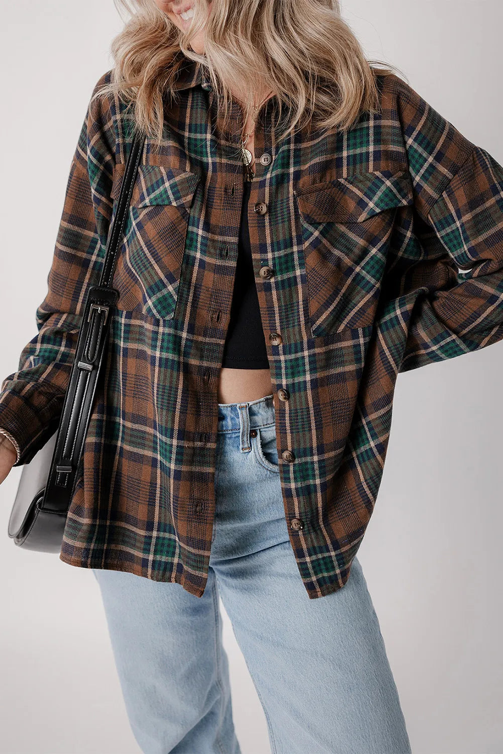 Plaid jacket in brown, green, and navy with button front and chest pockets.