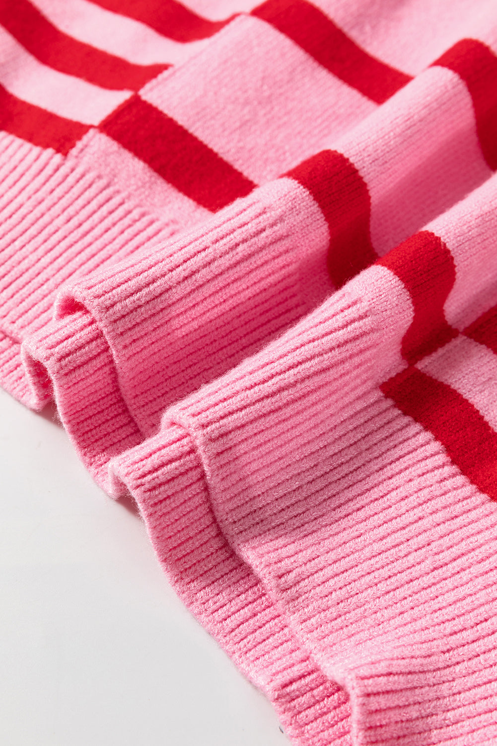 Colorblock stripe knit sweater in hot pink with red stripes and balloon sleeves.