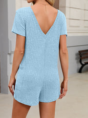 Light blue textured V-neck short romper with pockets and short sleeves.