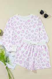 Pink leopard print loungewear set with crewneck top and drawstring shorts.