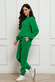 Green corduroy lounge set with crew neck sweatshirt and pocket detail, and matching jogger pants.