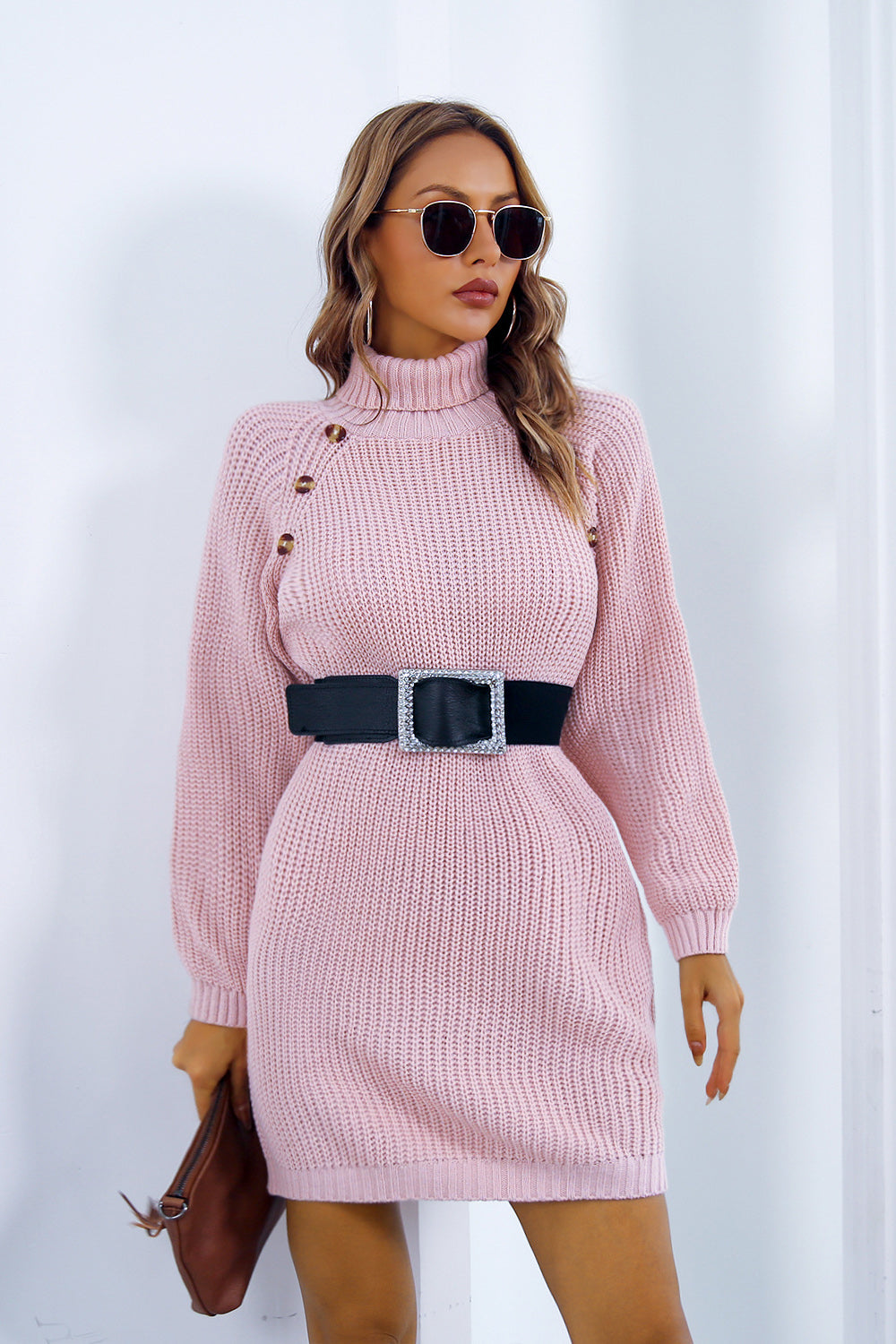 Pink knit turtleneck mini dress with button detail and black belt