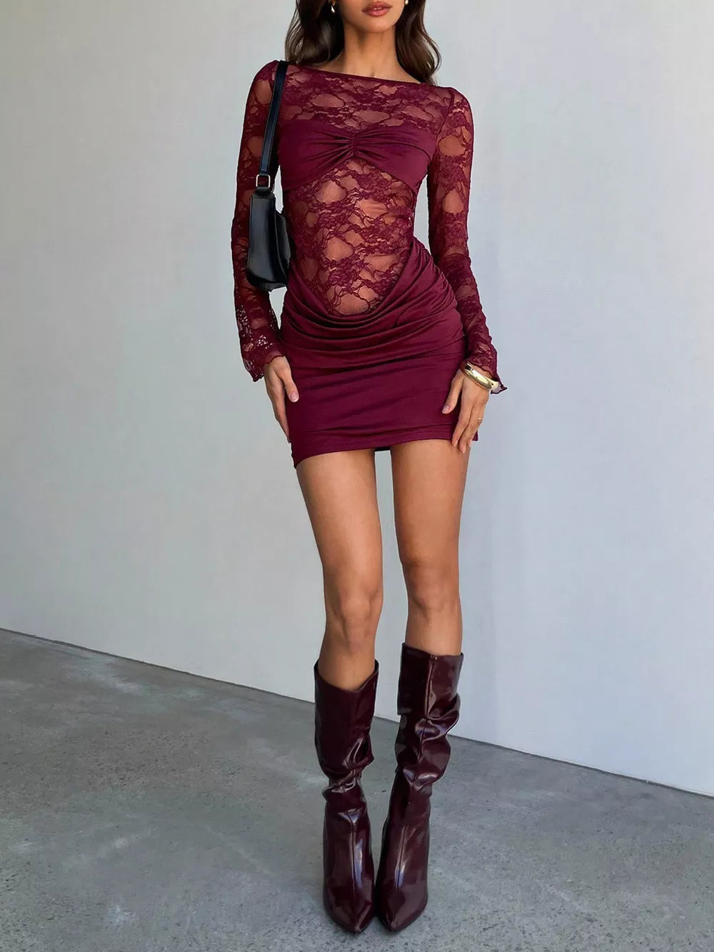 Burgundy lace ruched mini dress with draped detail and long sleeves.
