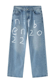 Medium wash baggy jeans with white painted script detail