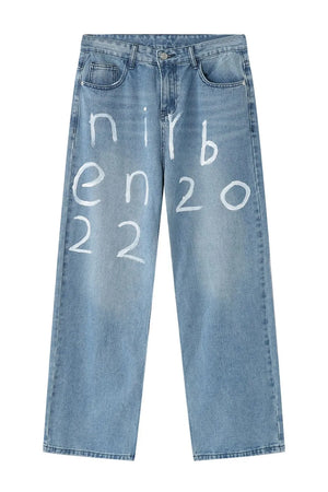 Medium wash baggy jeans with white painted script detail