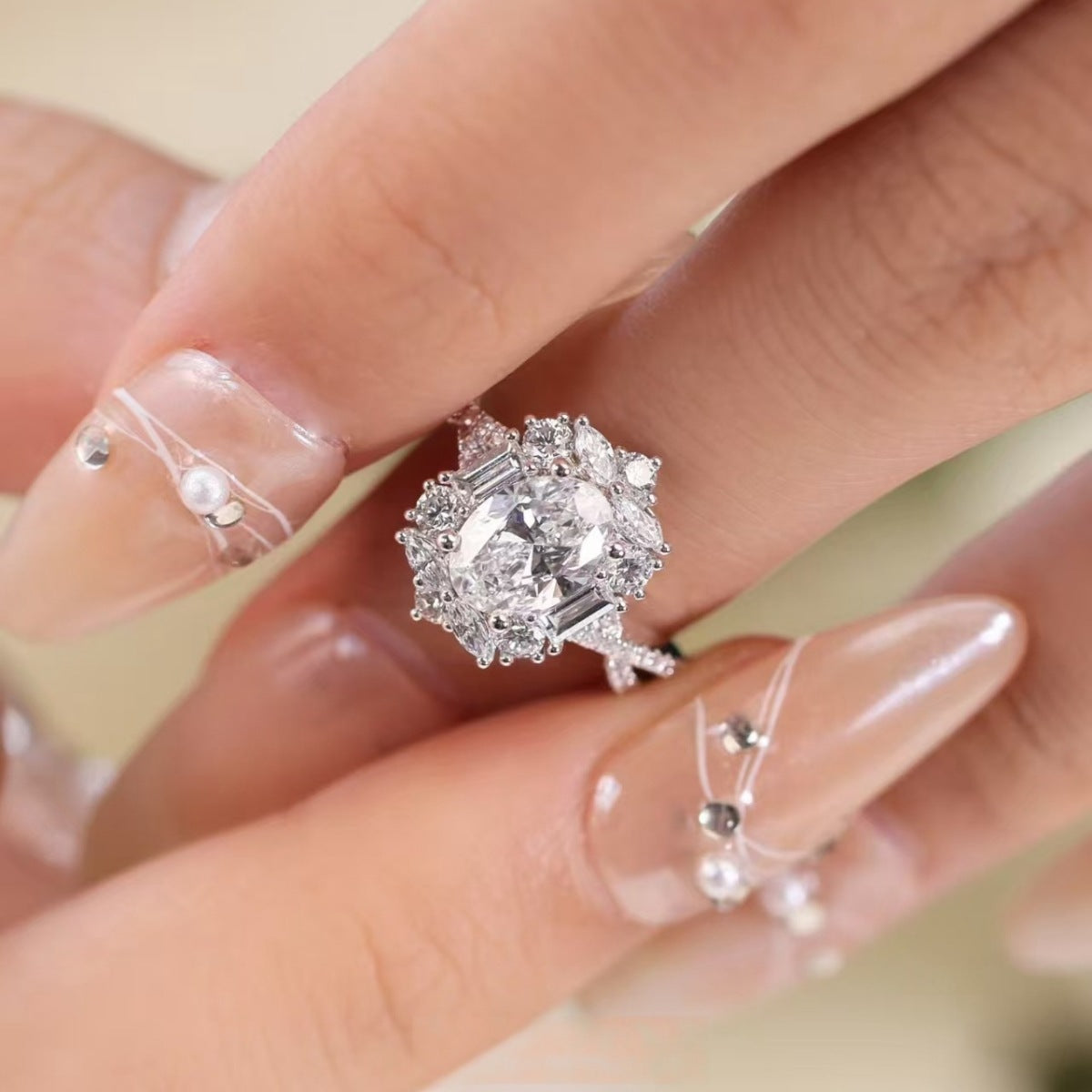 Sterling silver ring with oval moissanite center stone and diamond halo.